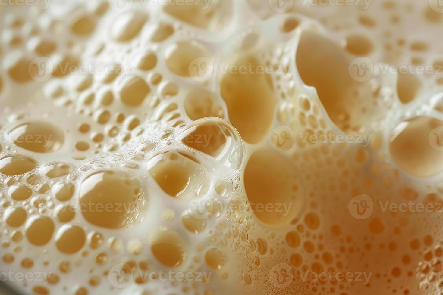 A close-up view captures the frothy surface of freshly brewed coffee, emphasizing the rich texture and inviting aroma. The warm tones create a comfortable atmosphere photo