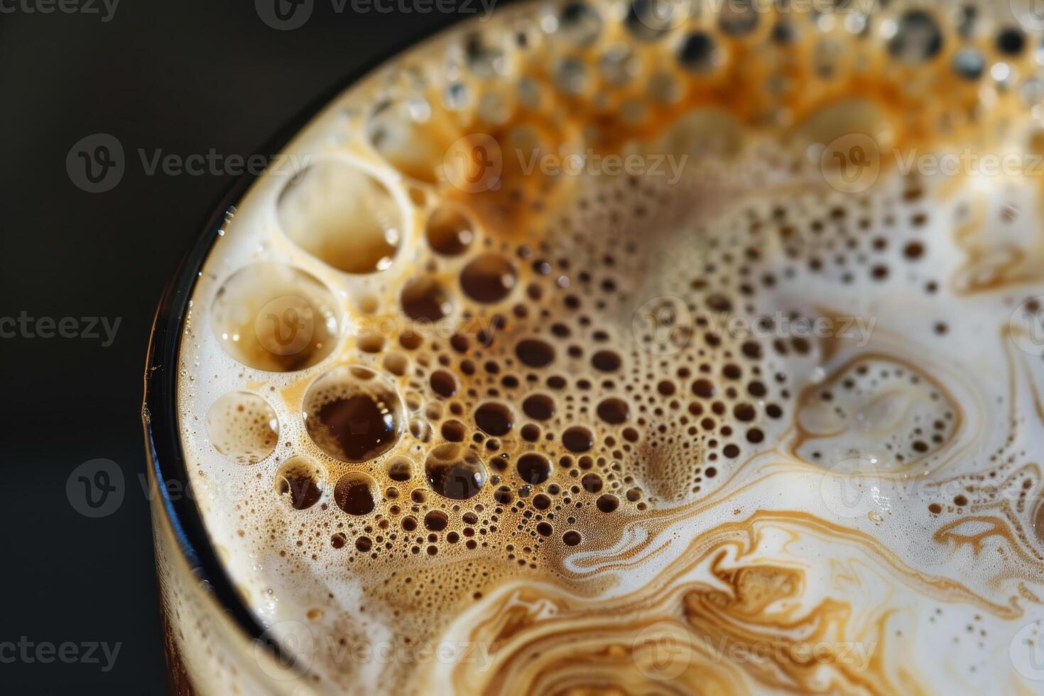 A close up of a glass of coffee with foam photo