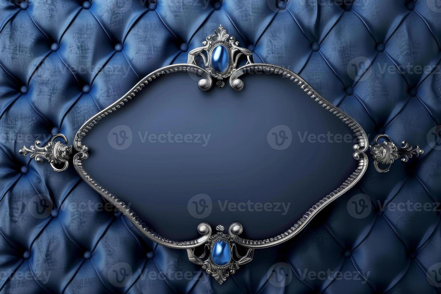 A refined blue tufted surface serves as a backdrop, enhanced by a decorative silver frame. The frame features intricate designs, suitable for displaying text or art photo