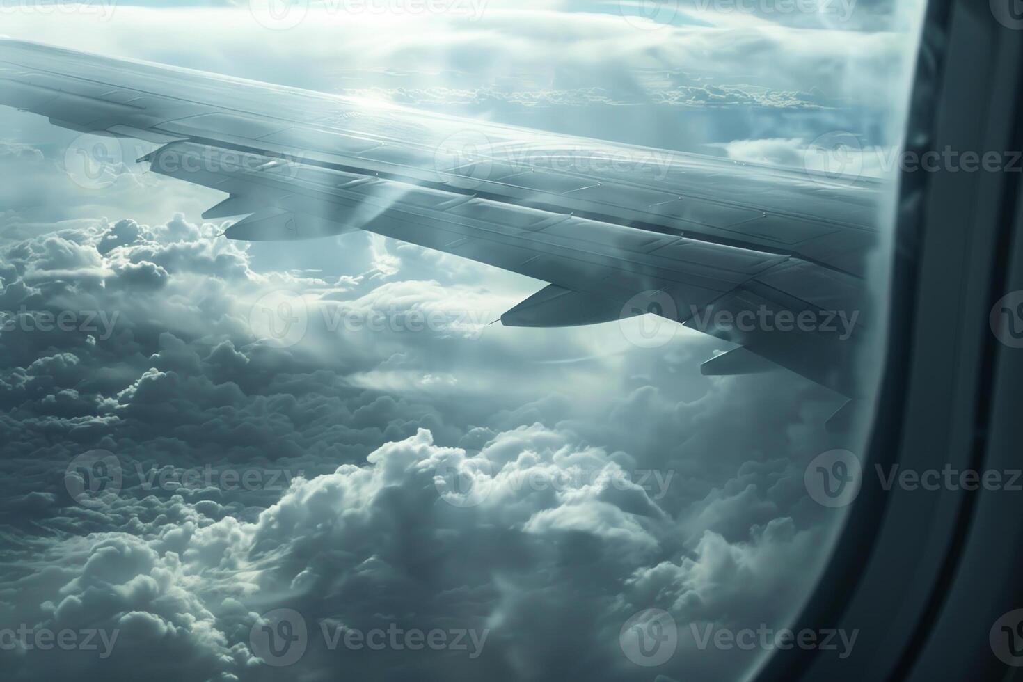 The airplane wing extends into the cloudy sky, surrounded by thick layers of clouds and a soft, diffused light creating a serene atmosphere during the journey photo