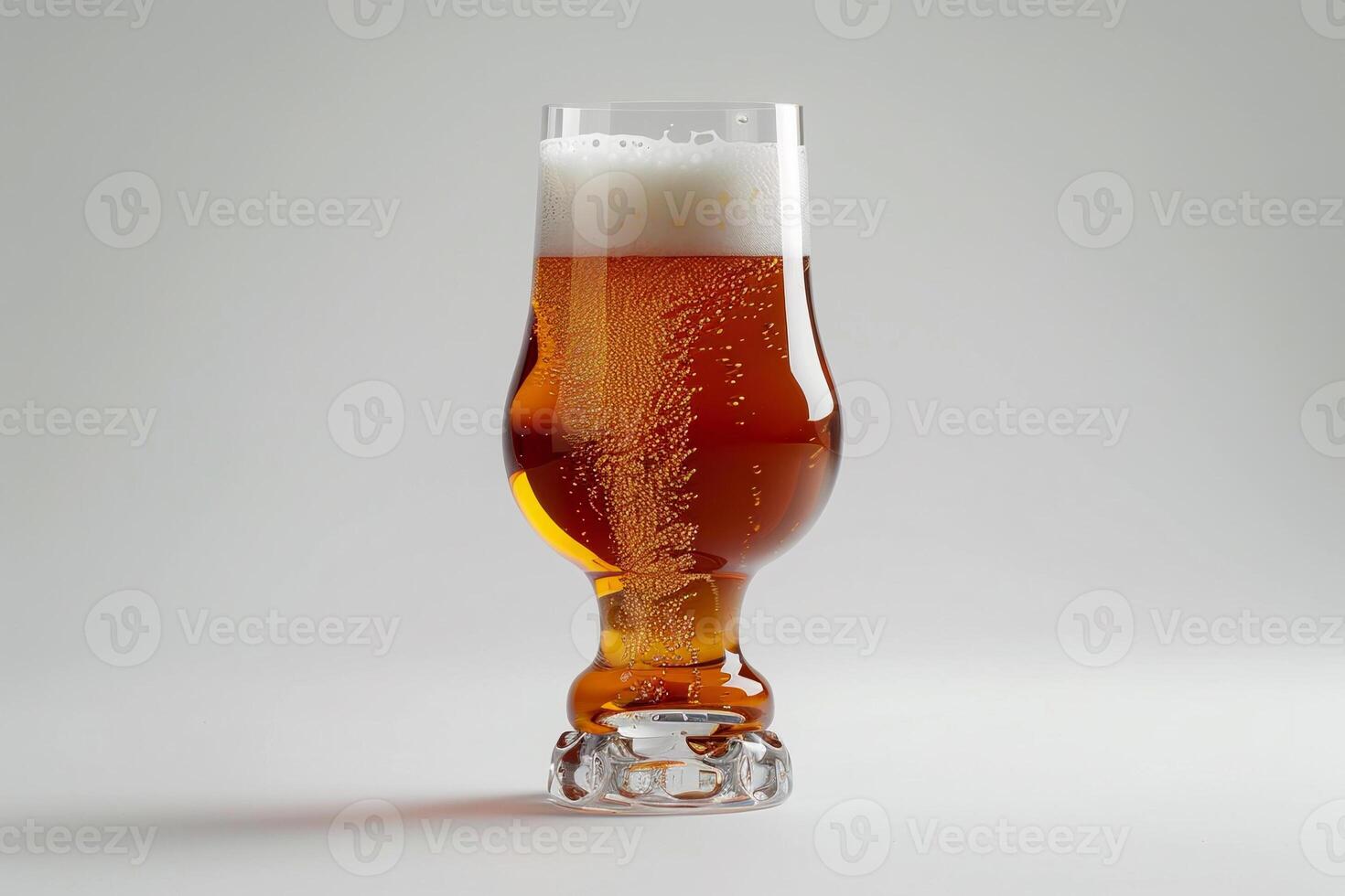 A tall, elegant glass holds a refreshing amber beer with a thick, frothy head. Bubbles rise to the top, creating a visually appealing drink on a matte white background photo