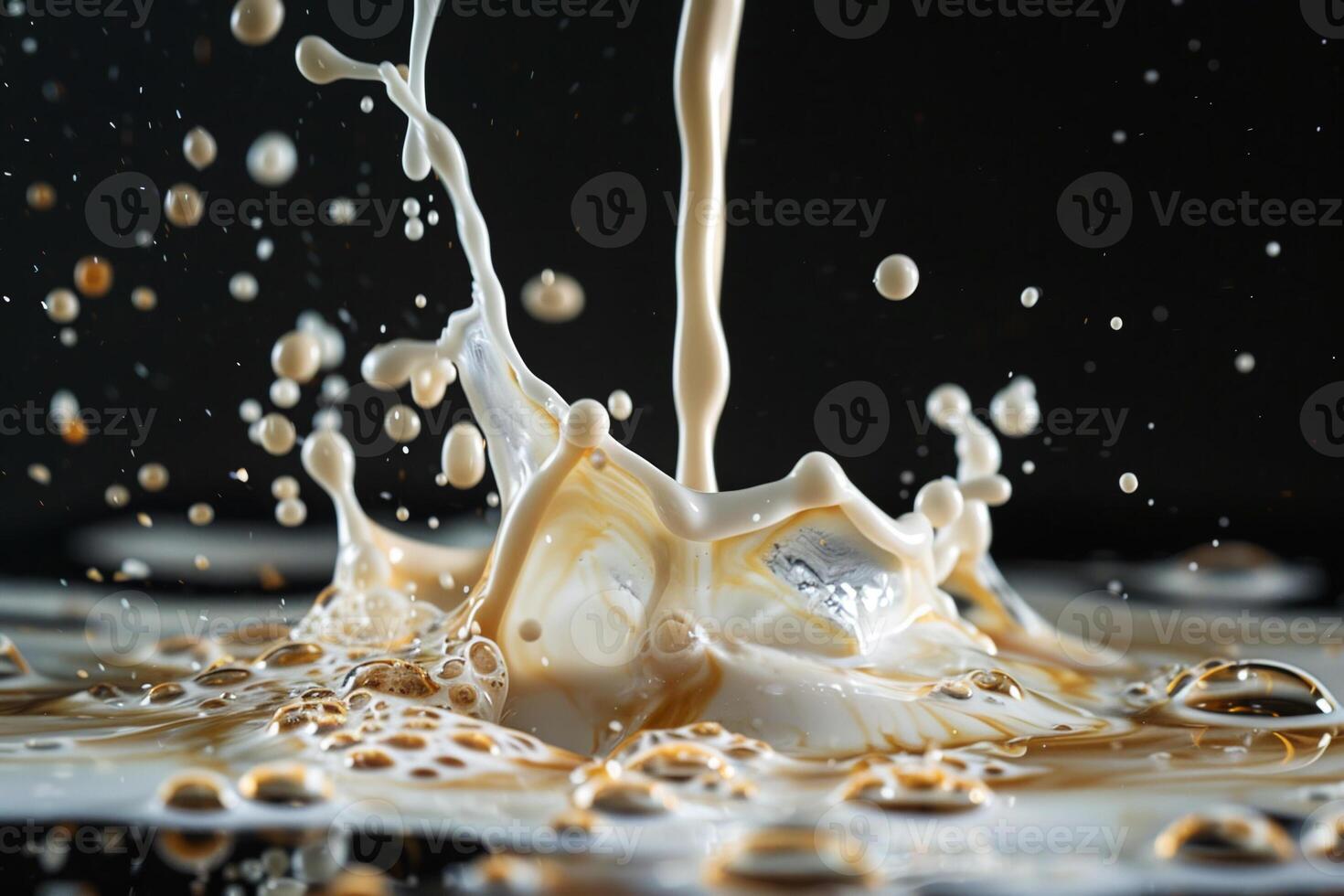 A splash of milk is being poured into a glass photo