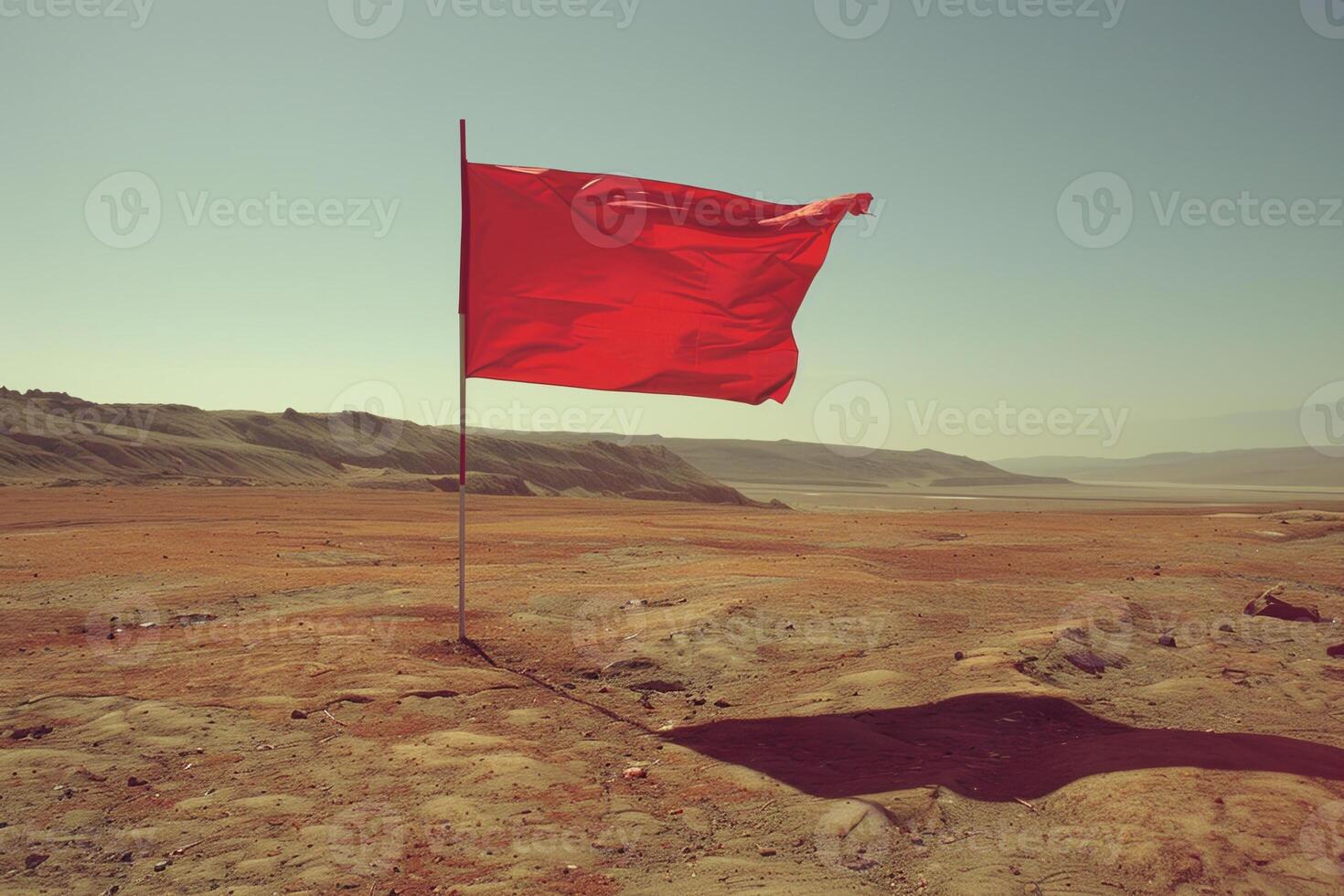 A red flag is flying in the desert photo