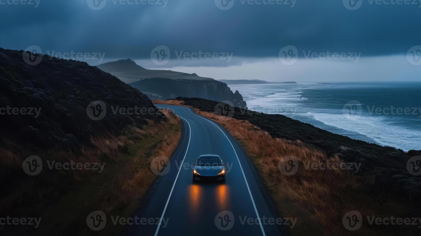 A car driving on a road near the ocean photo