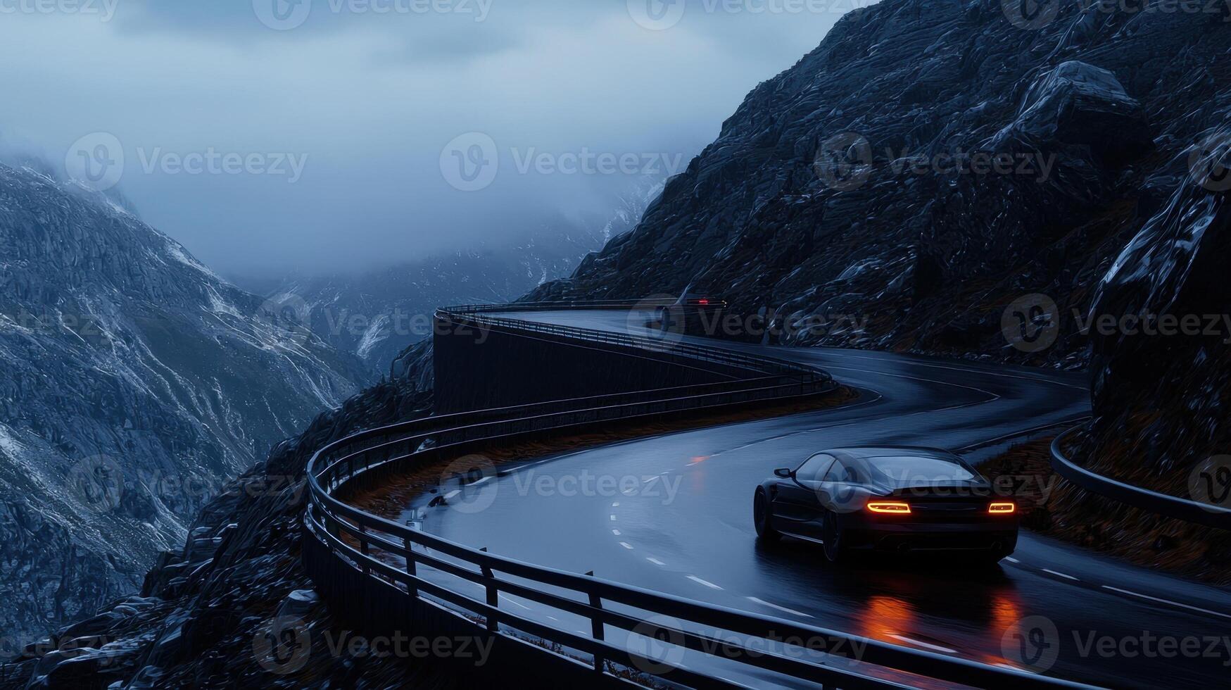 A car driving down a mountain road at night photo