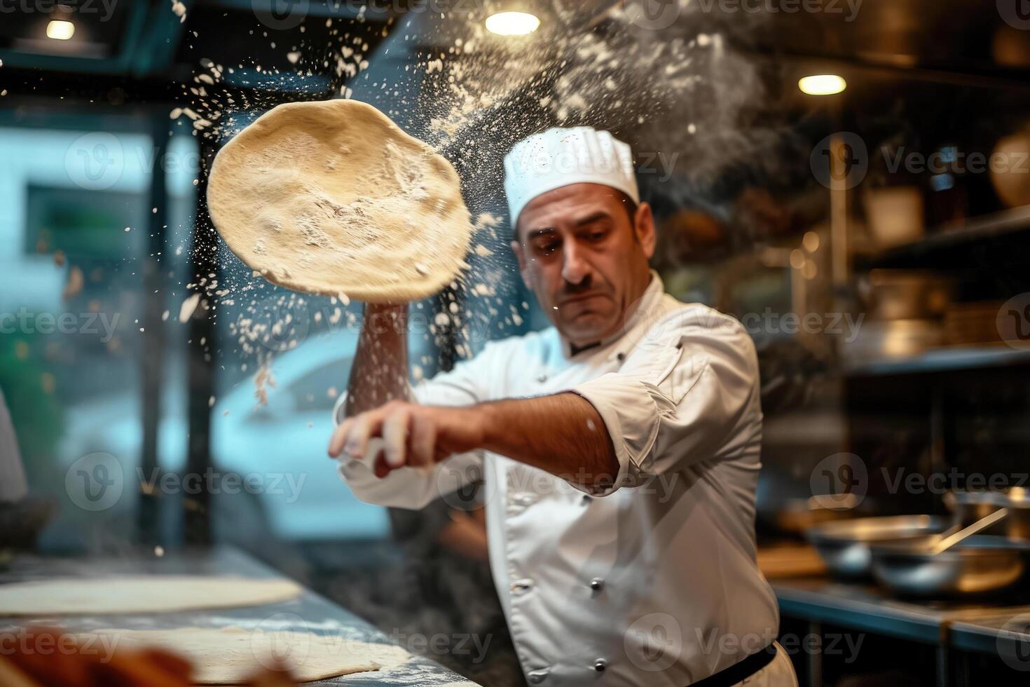 Chef throwing flour on dough in kitchen photo