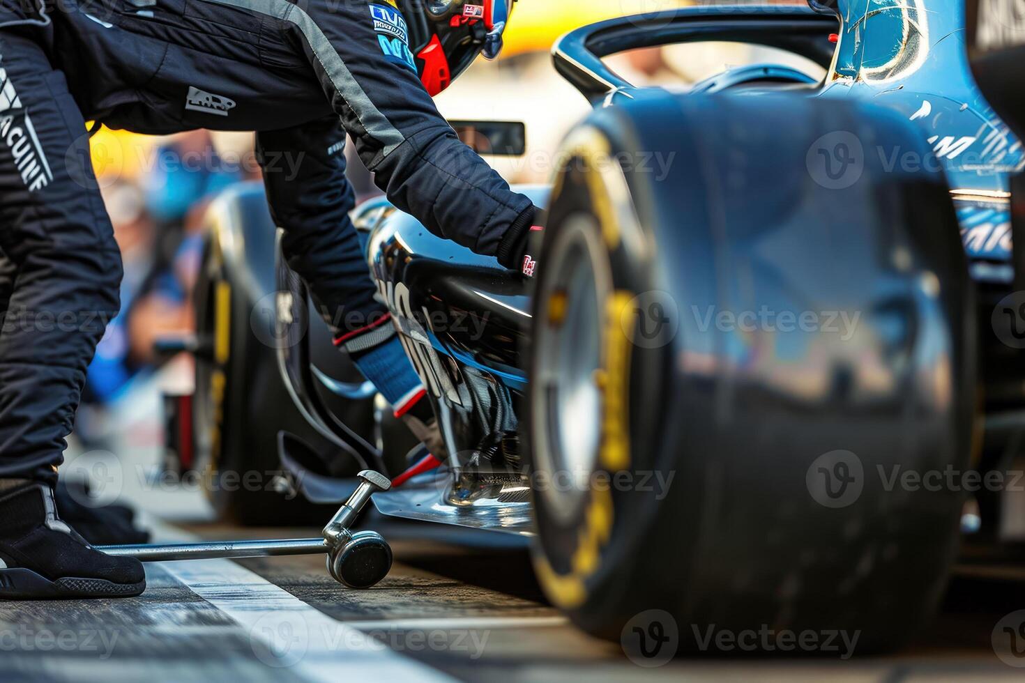 A man in black and red standing next to a race car photo