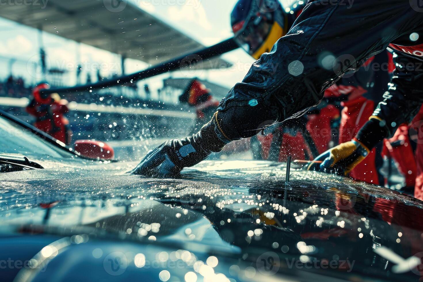 A person washing a car with a hose photo
