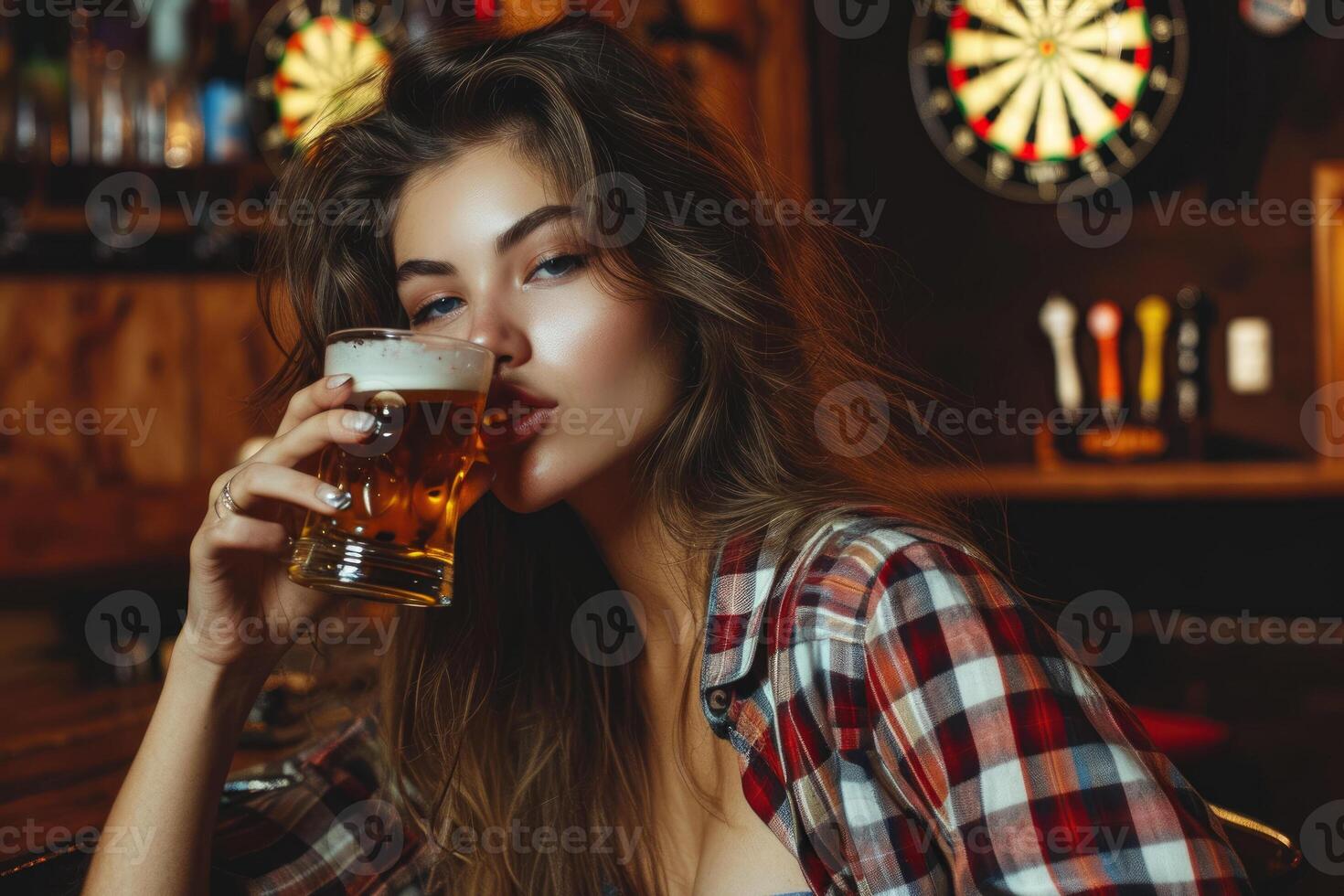 A woman is drinking a beer in a bar photo