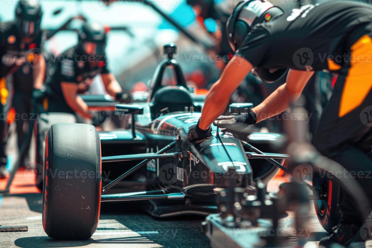 A man is working on a race car photo
