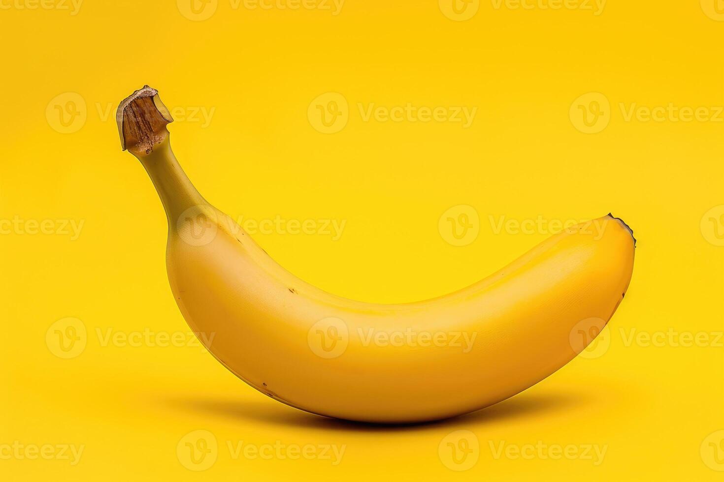 A banana is sitting on a yellow background photo