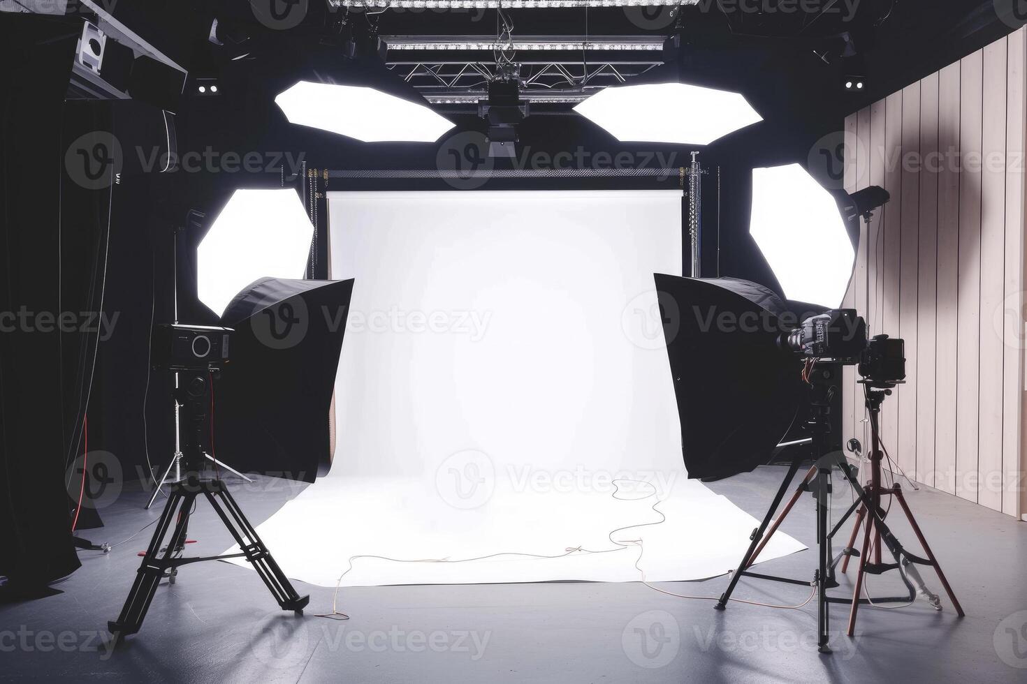 A photo studio with lights and a white backdrop