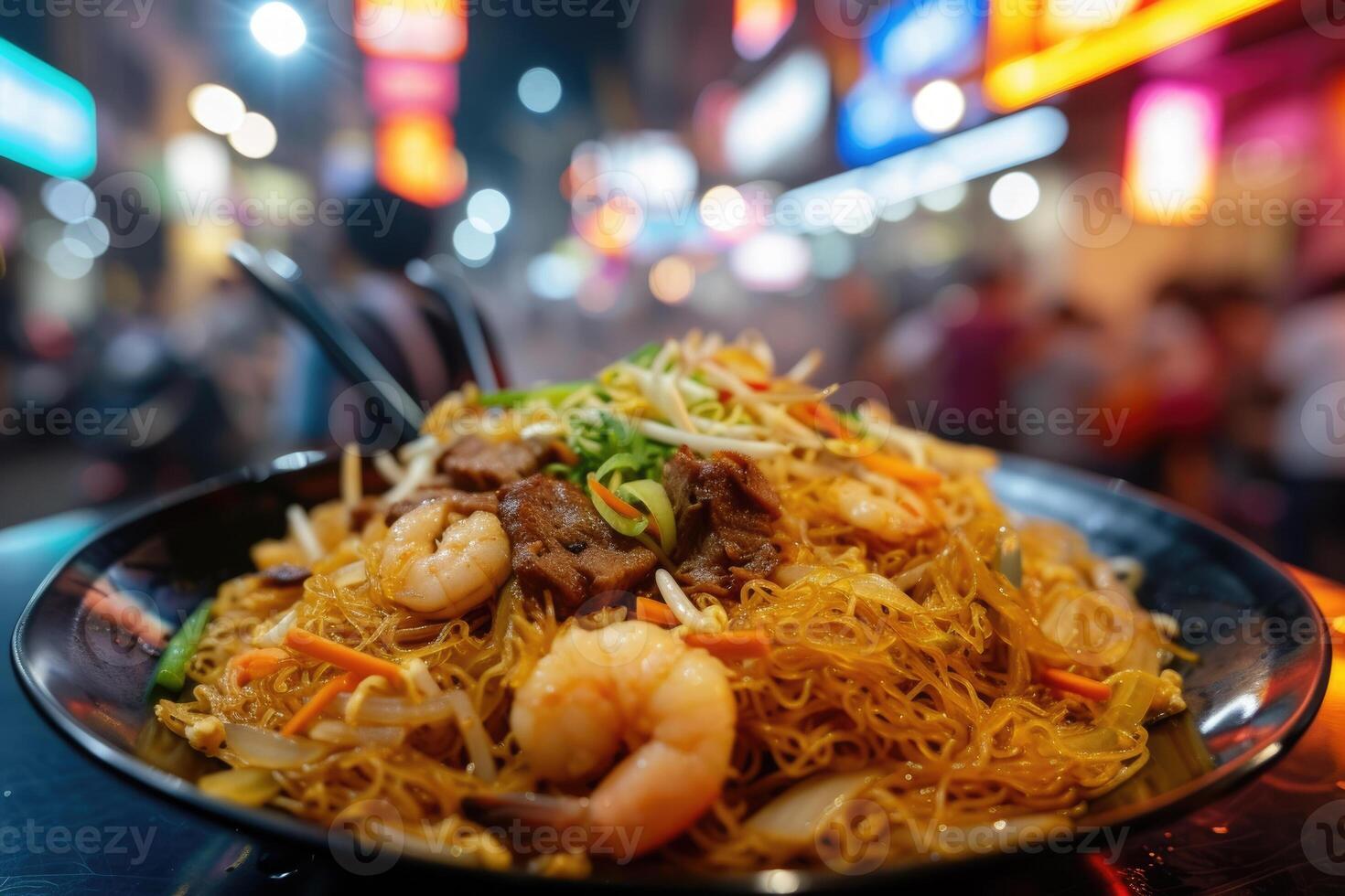 A bowl of noodles with shrimp and vegetables photo
