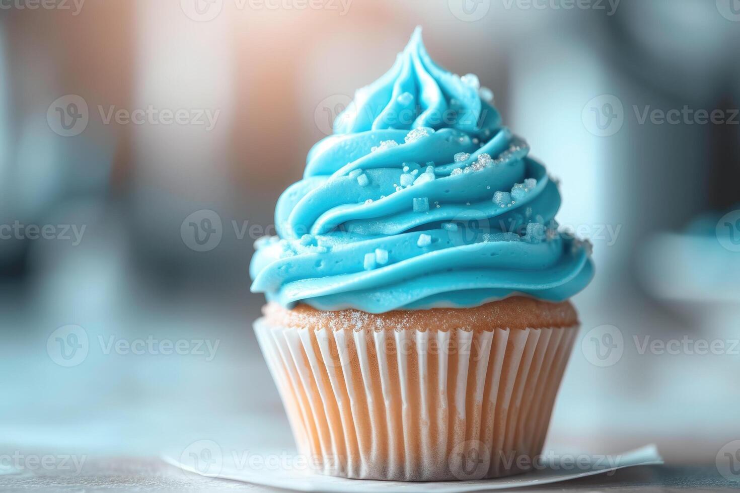A cupcake with blue frosting on top photo
