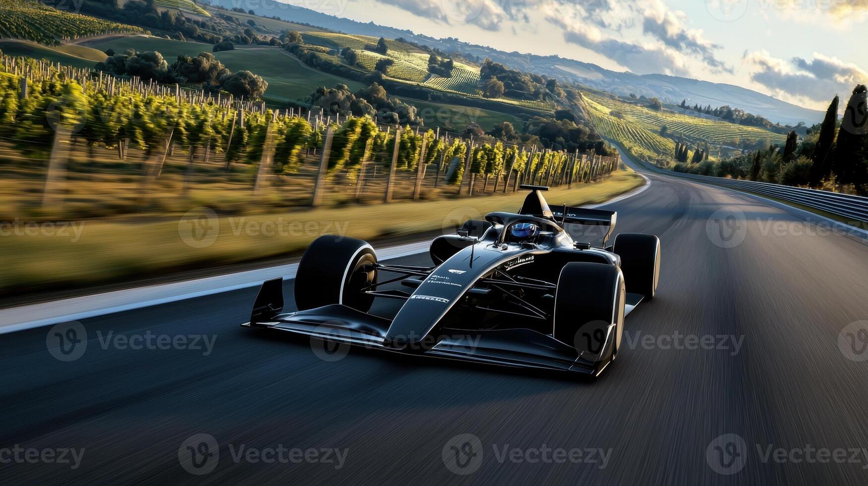 A racing car driving down a road with vineyards in the background photo