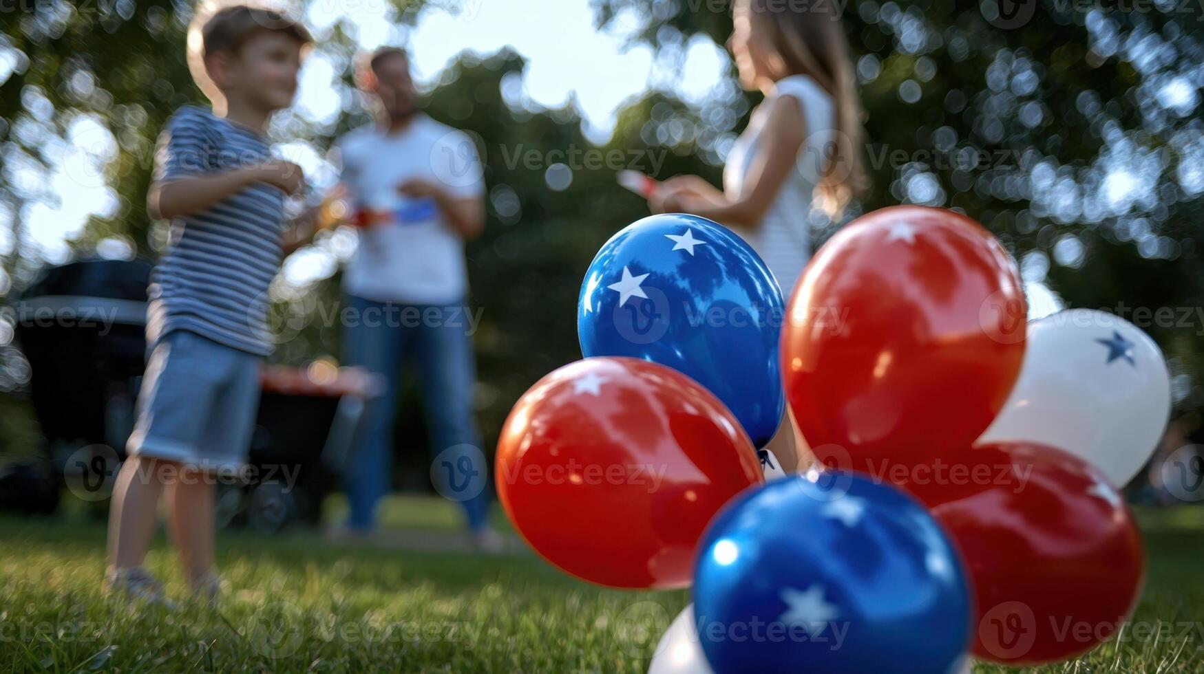 A family of four is enjoying a day at the park, with a bunch of red, white photo