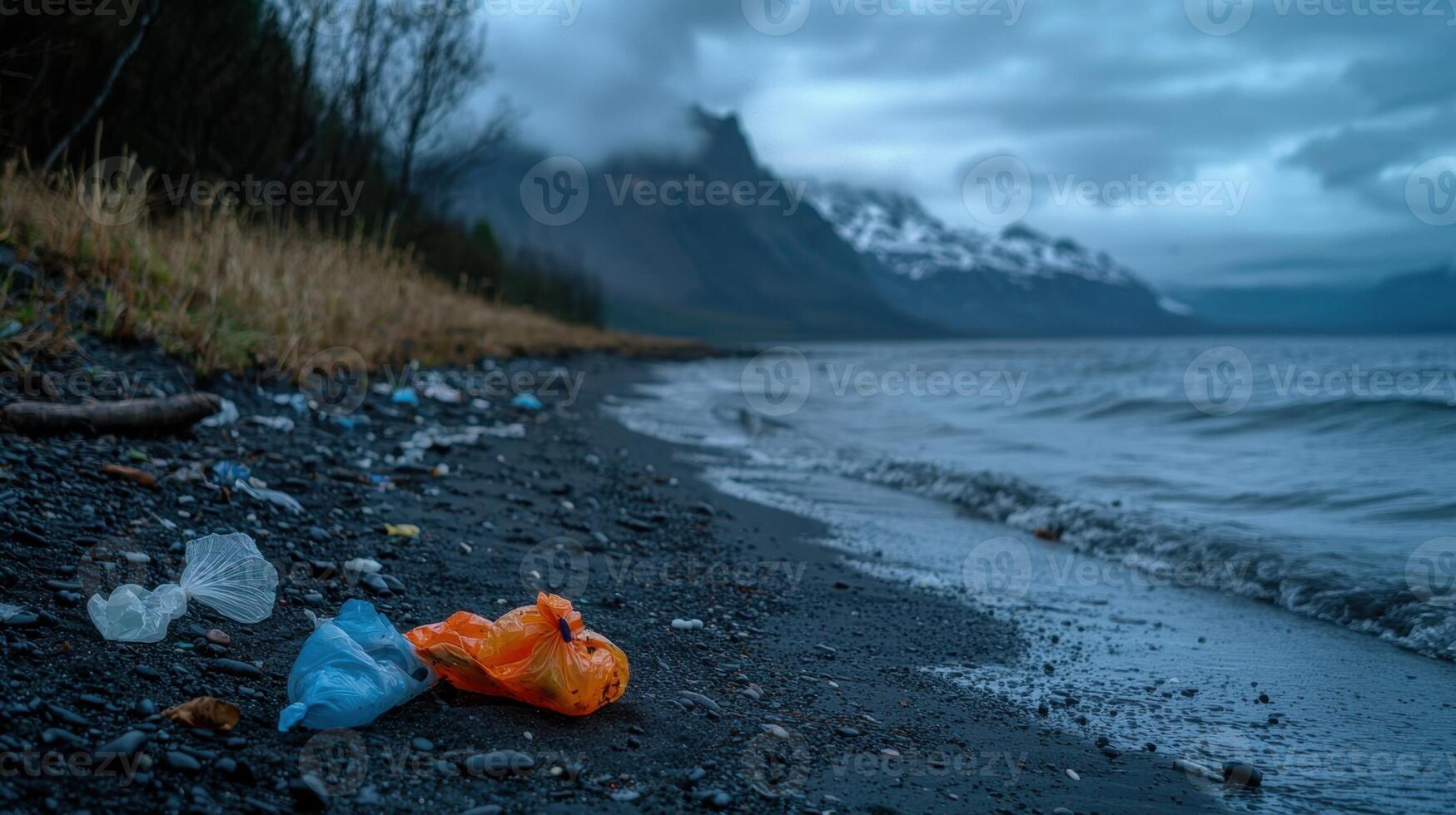 A beach with a mountain in the background and a plastic bag on the sand photo