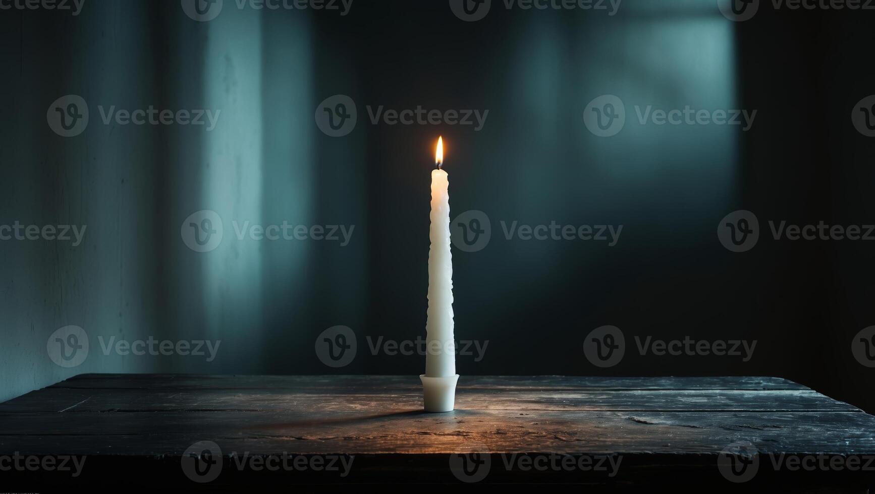 Candle flickering in a dimly lit room creating a calm and serene atmosphere during the evening hours photo