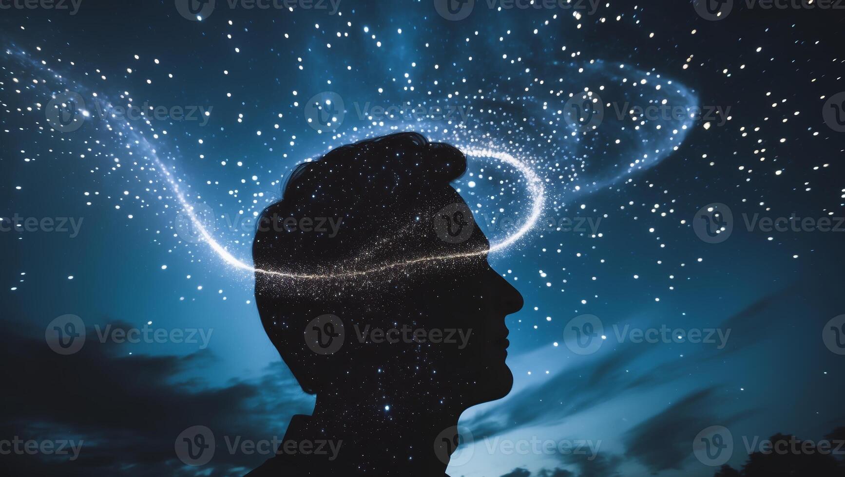 Creative silhouette of a person with swirling galaxies above their head depicting imagination and wonder at night photo