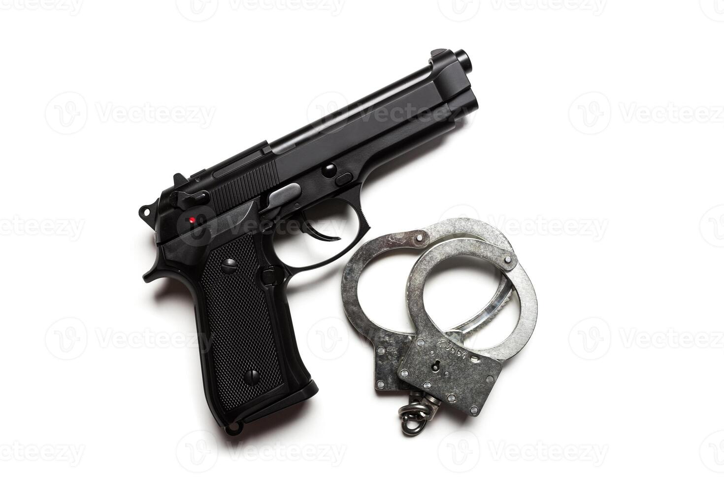 gun and handcuffs on white background photo