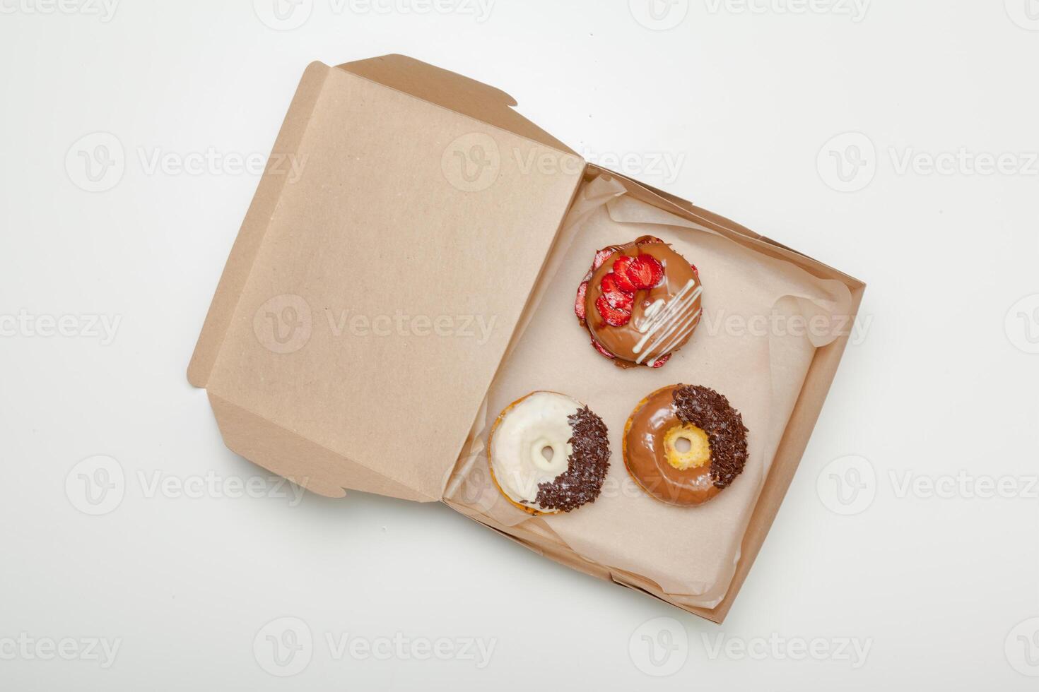 box of fresh donuts isolated on white photo
