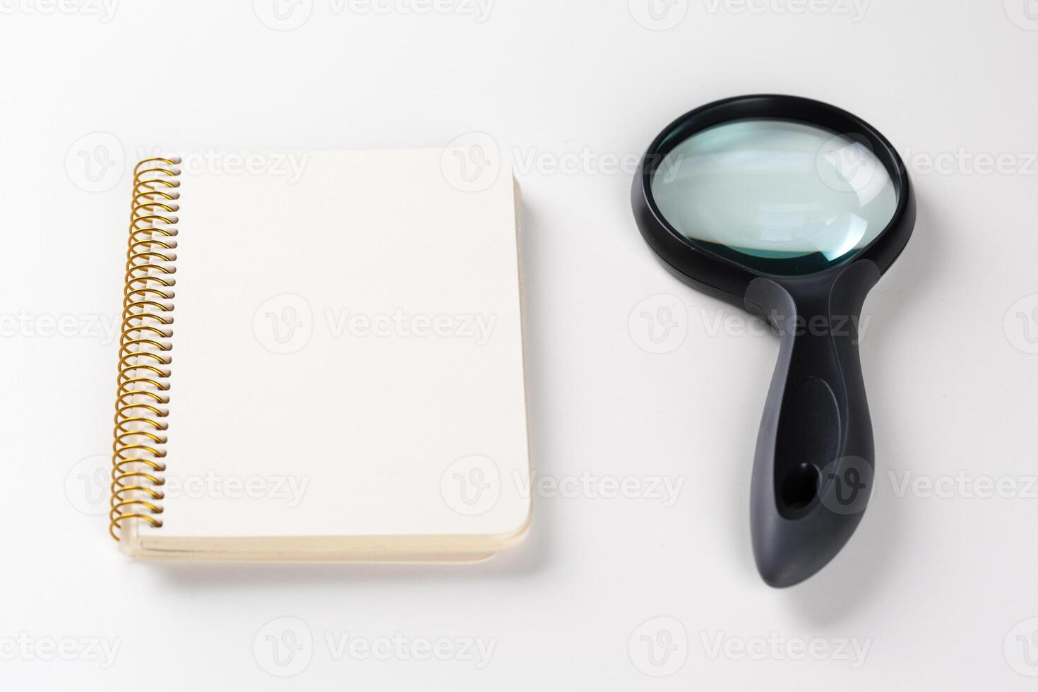 notebook and magnifying glass.research idea photo