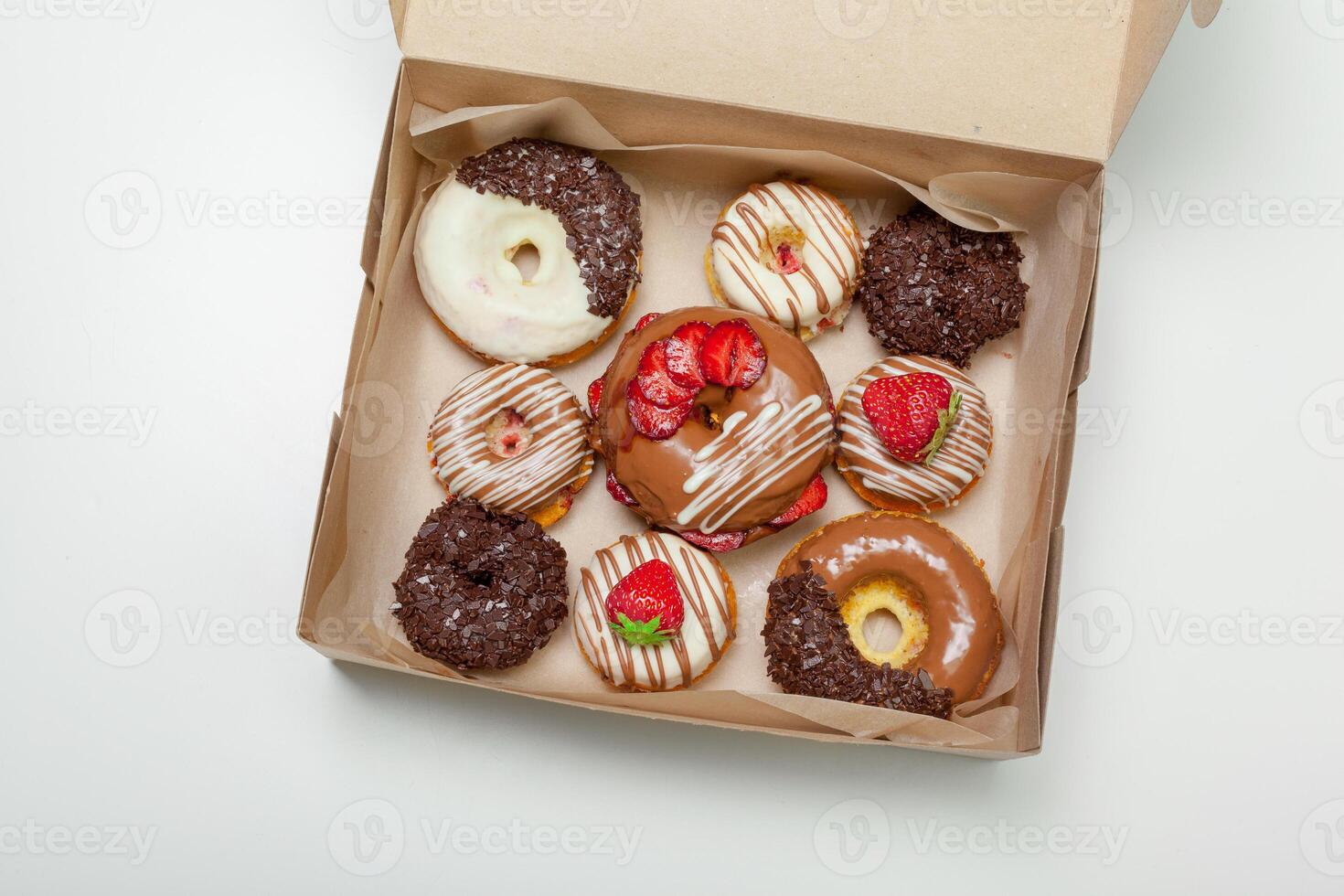 box of fresh donuts isolated on white photo