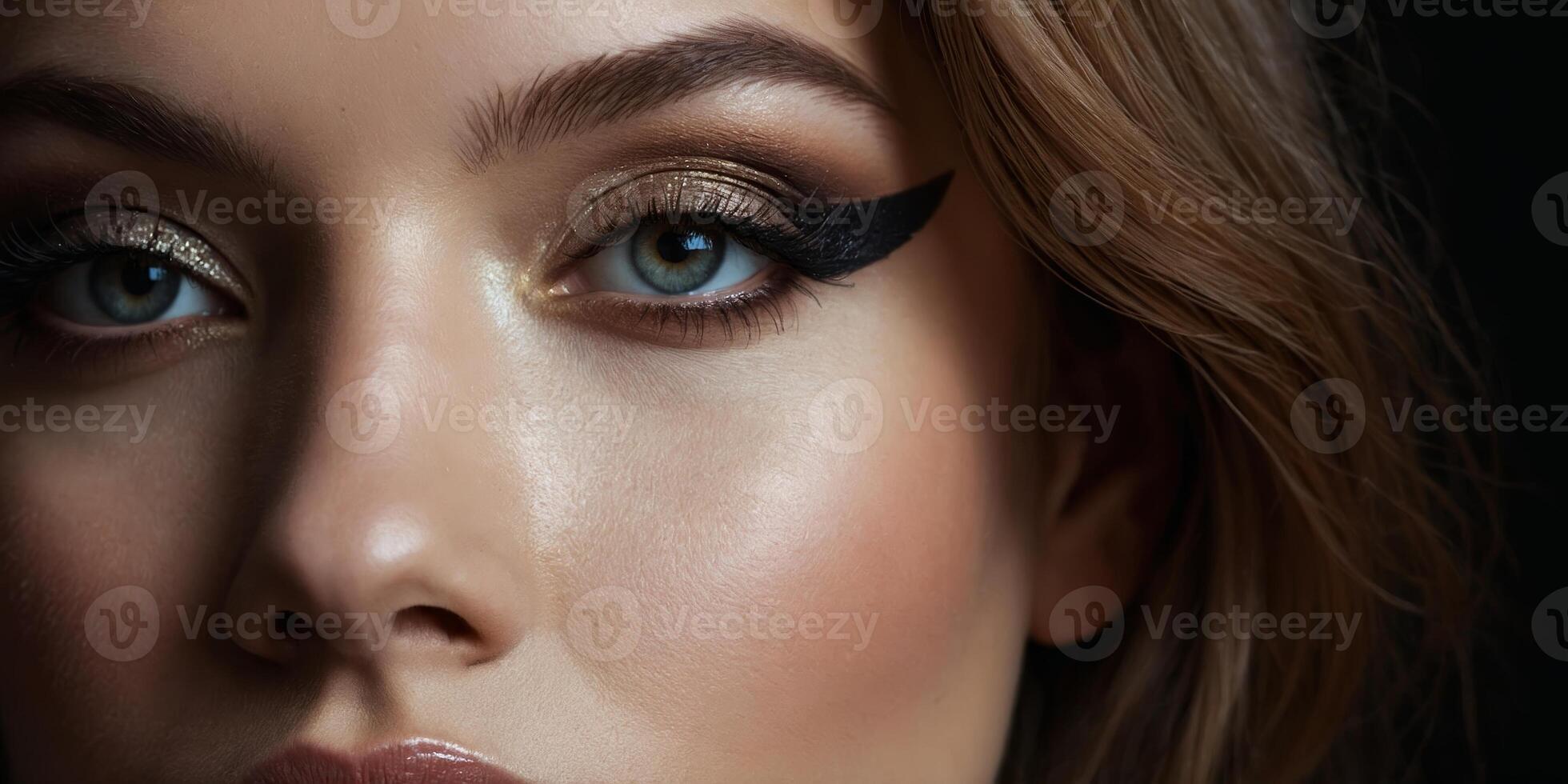 Stunning close-up portrait of a woman showcasing bold makeup and captivating blue eyes in a dark setting photo