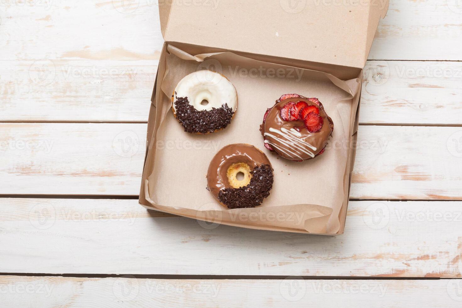 Colorful donuts in box photo
