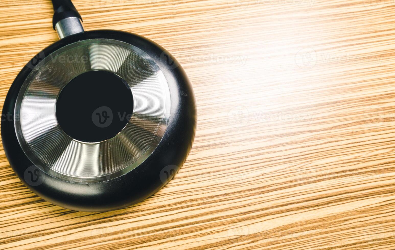 Frying pan on wooden table background. View from above photo