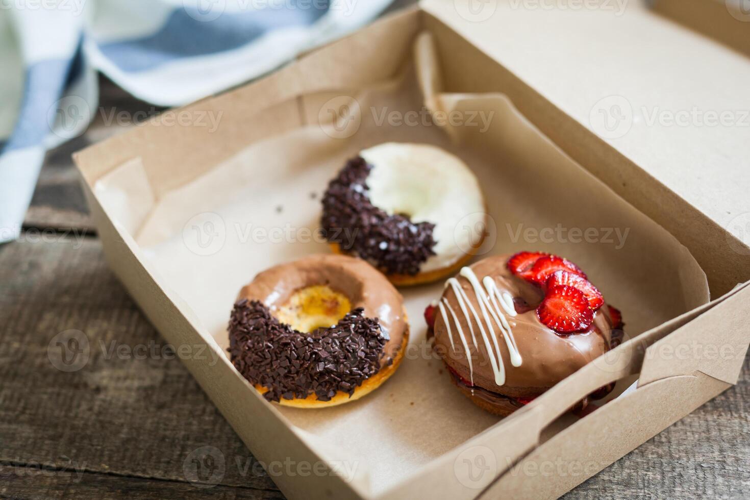 Colorful donuts in box photo