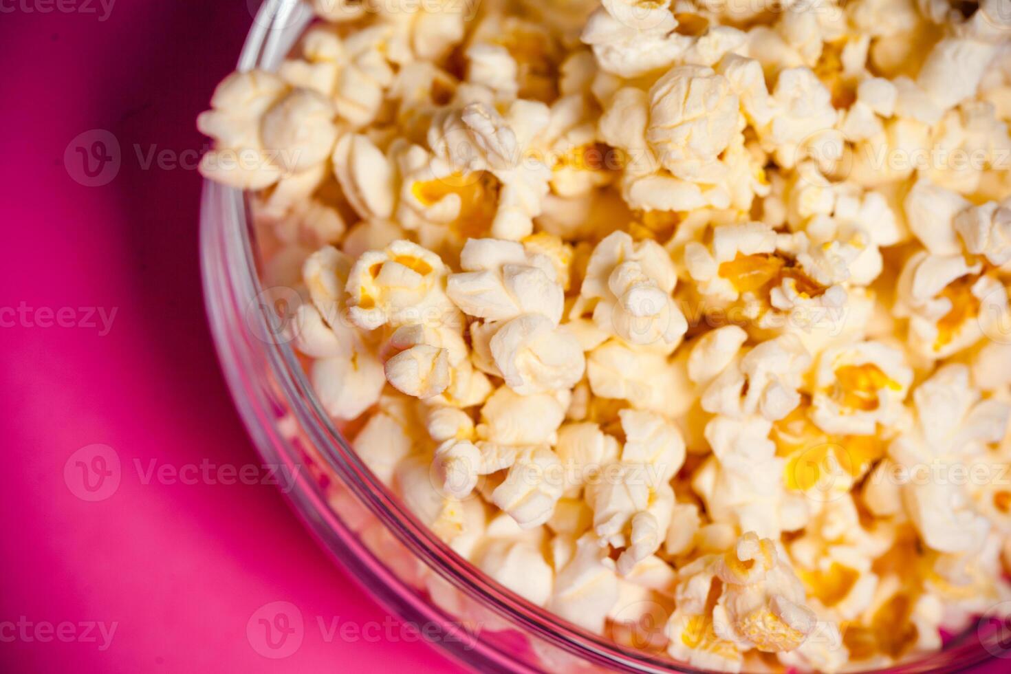 bowl with popcorn on red background photo