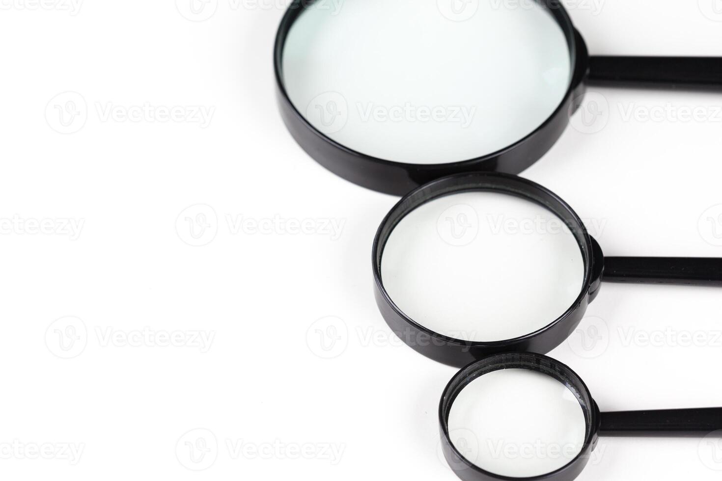 Three magnifiers over white photo
