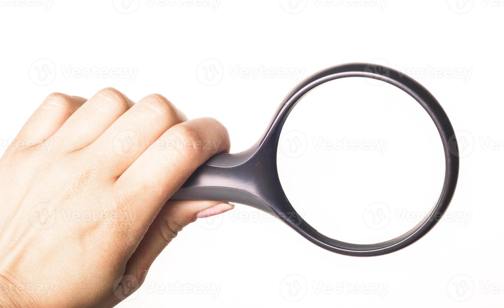 Hand holding magnifying glass isolated on white background photo