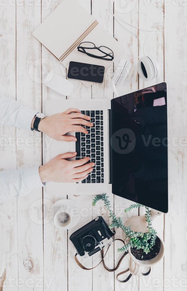 Businessman at work. Close-up top view of man working on laptop photo