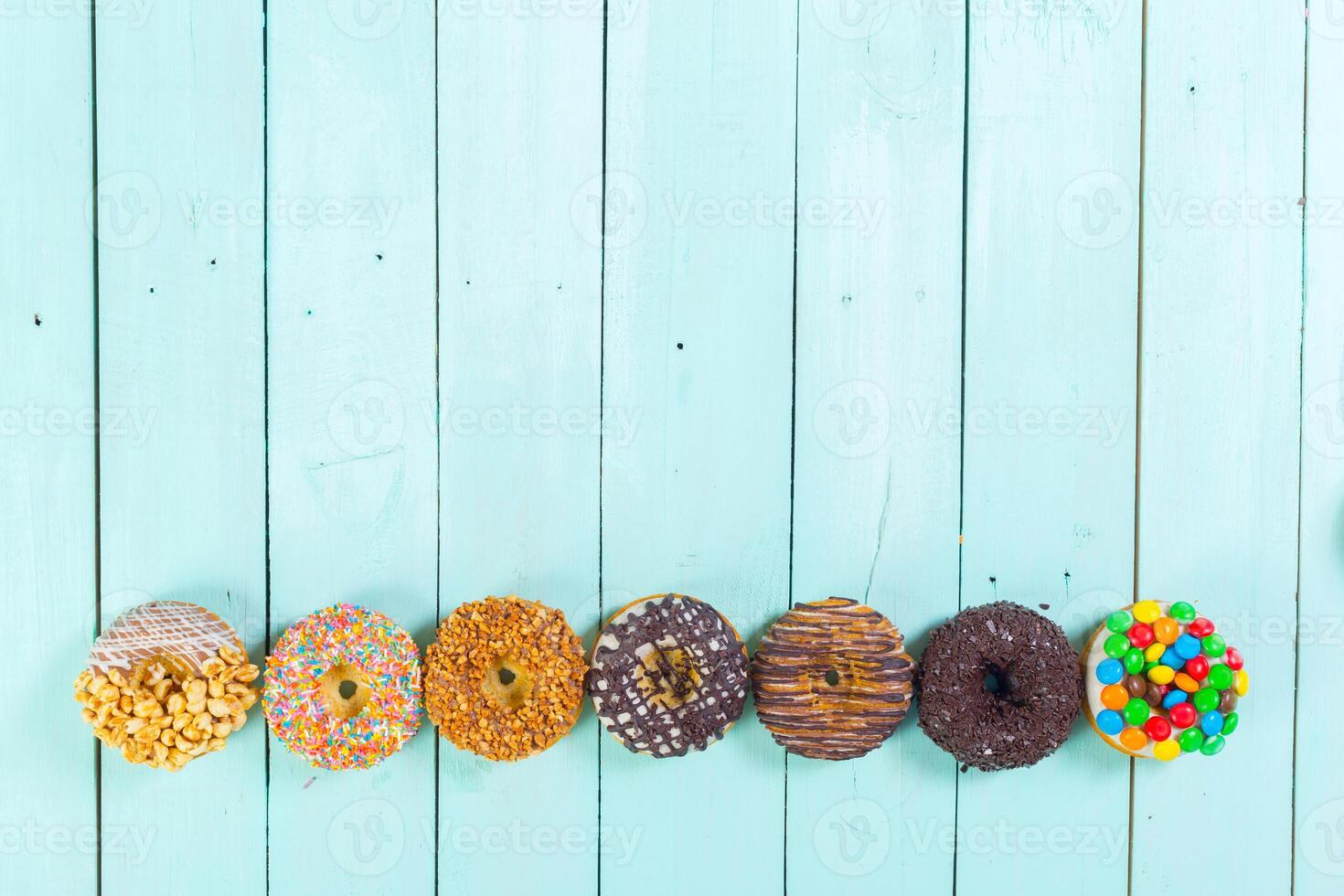 Donuts on wooden background photo