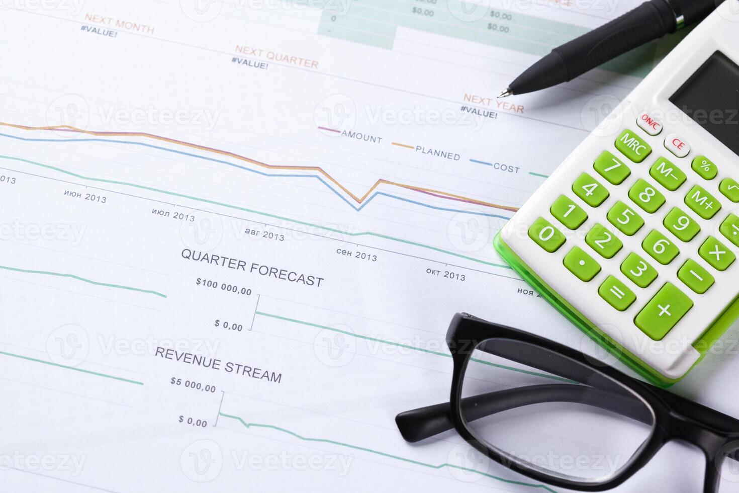 work with a magnifying glass, a calculator and papers photo