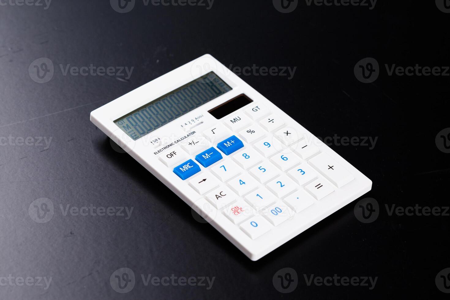 Calculator on black background photo