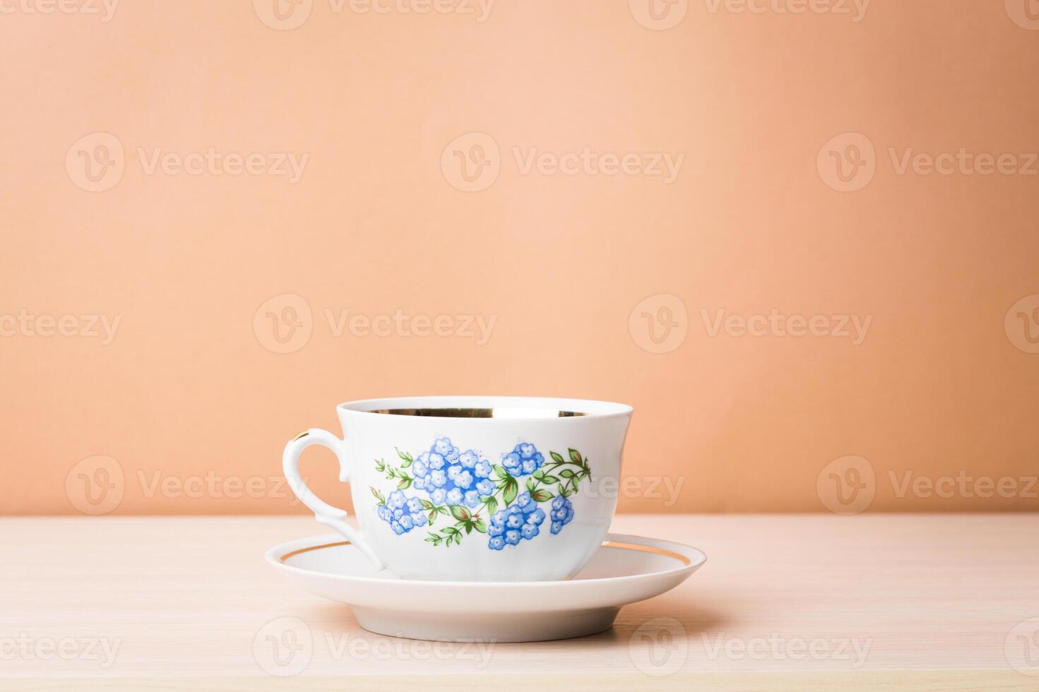 Cup of black tea in a china cup and saucer photo