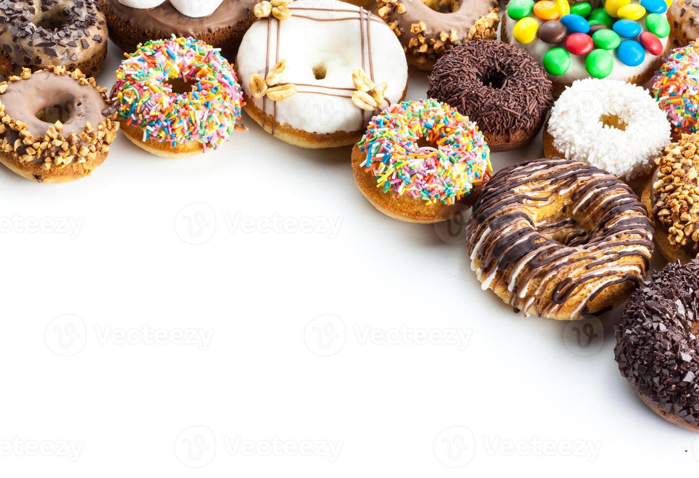 Delicious donuts with icing isolated on white photo