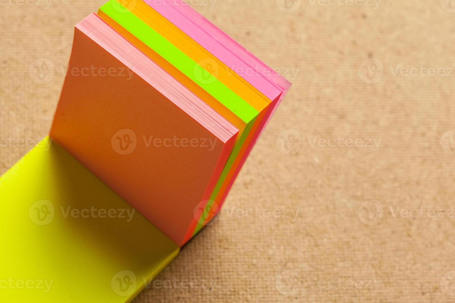 Color sticker notes over cork board background photo