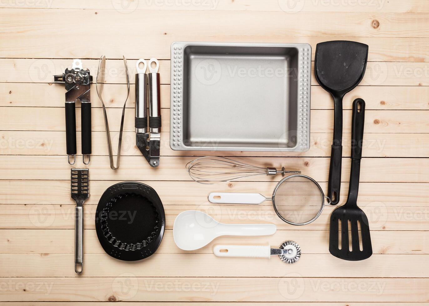cookware and accessories on a wooden table. photo