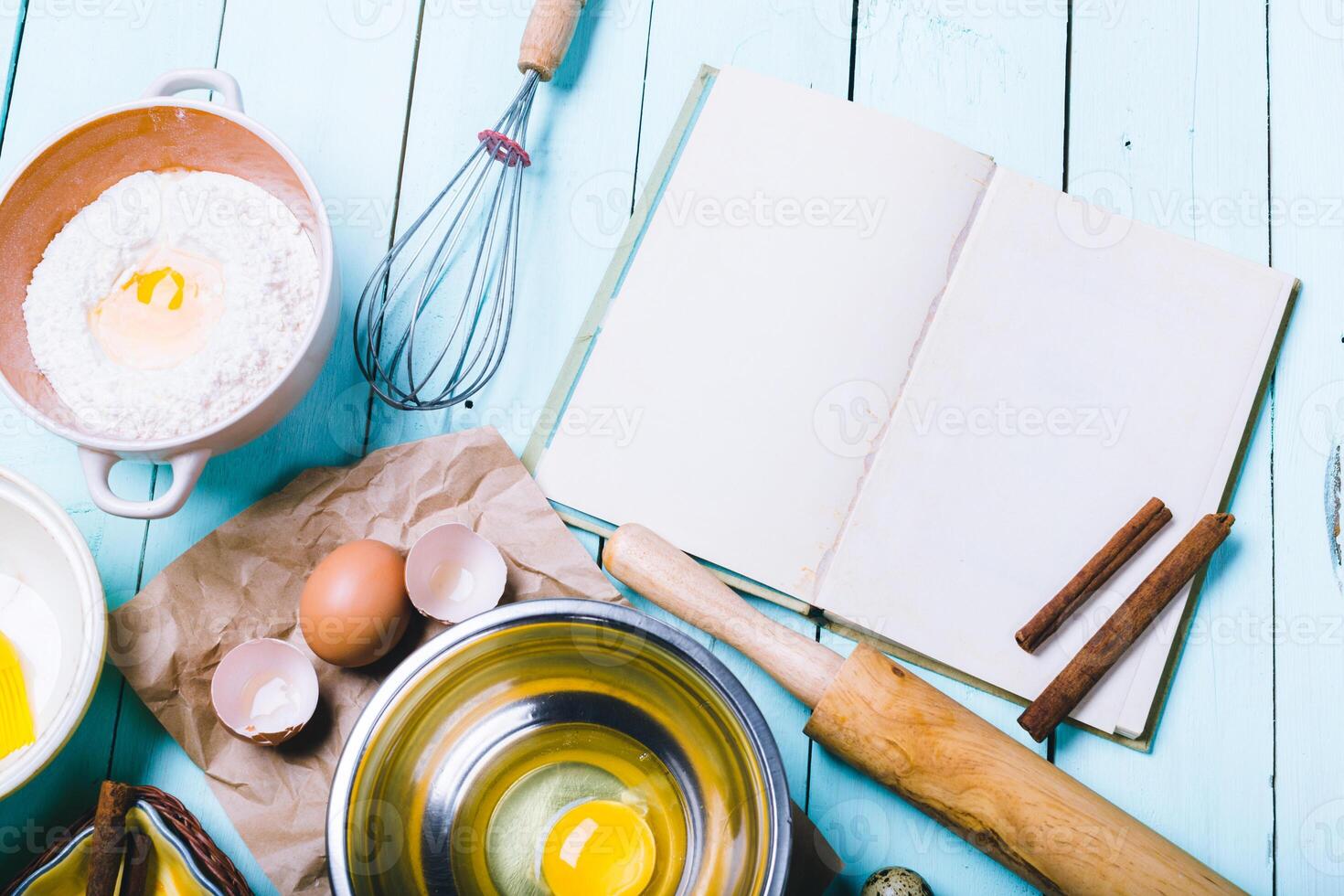 Preparation of the dough. Ingredients for the dough - Eggs and flour with a rolling pin. On wooden background. photo