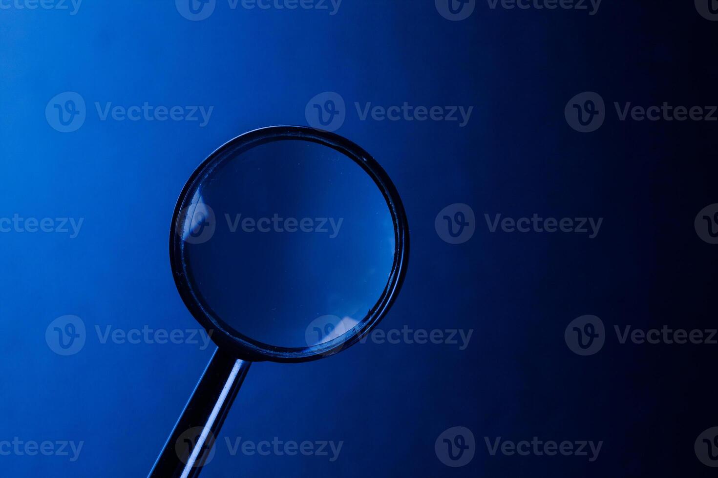 magnifying glass on dark background photo
