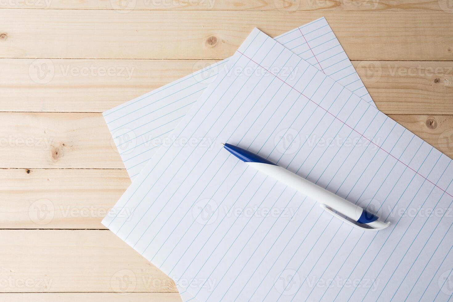 close-up of ball point pen over lined paper photo
