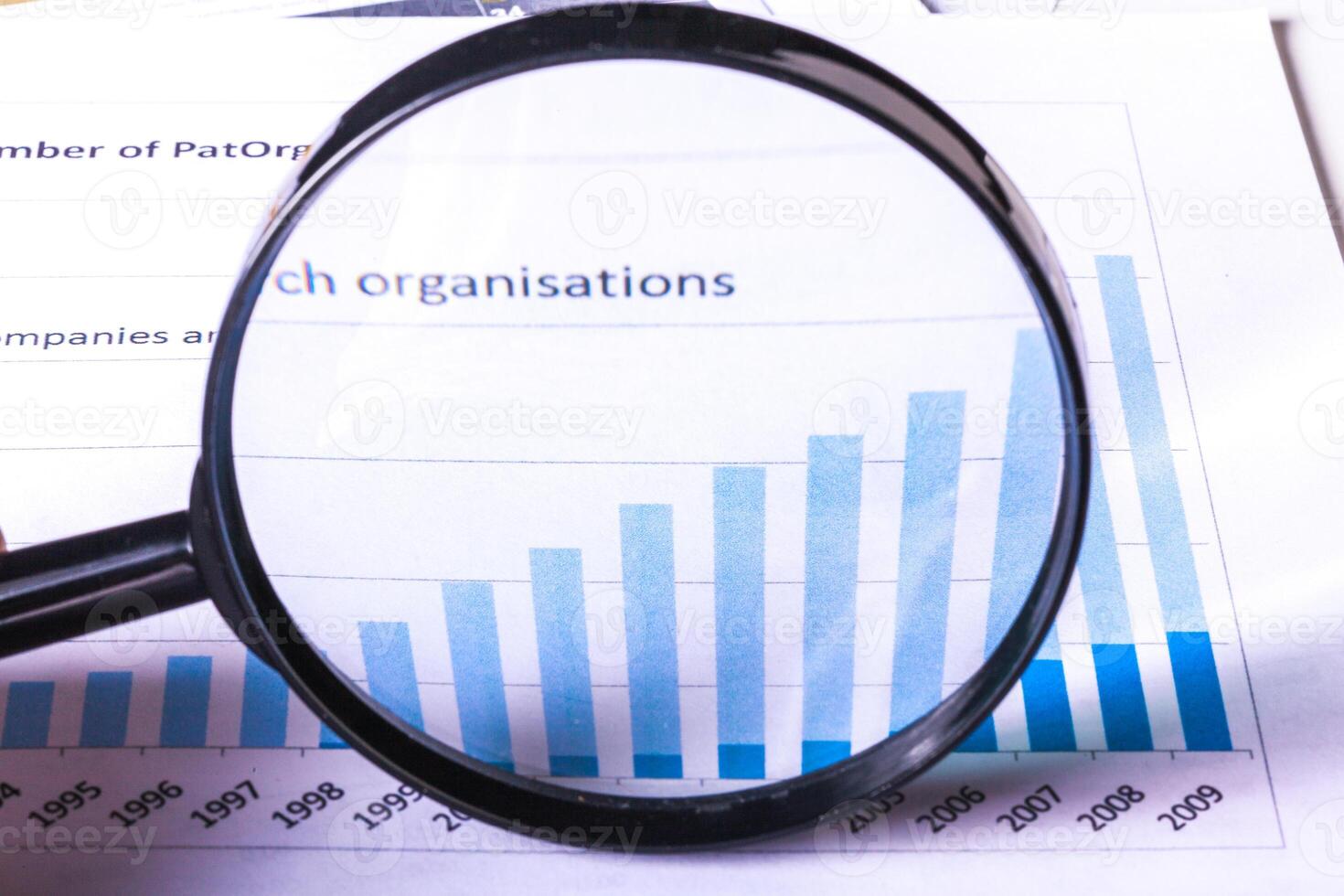 Magnifying glass and business growth graph photo