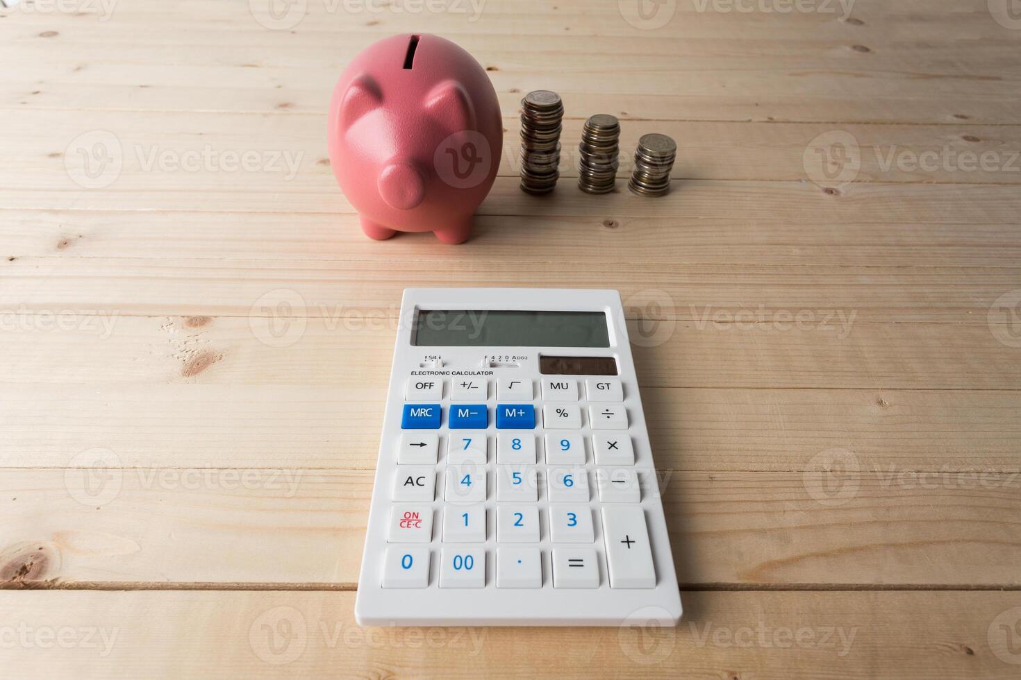 piggy bank with coins and calculator photo