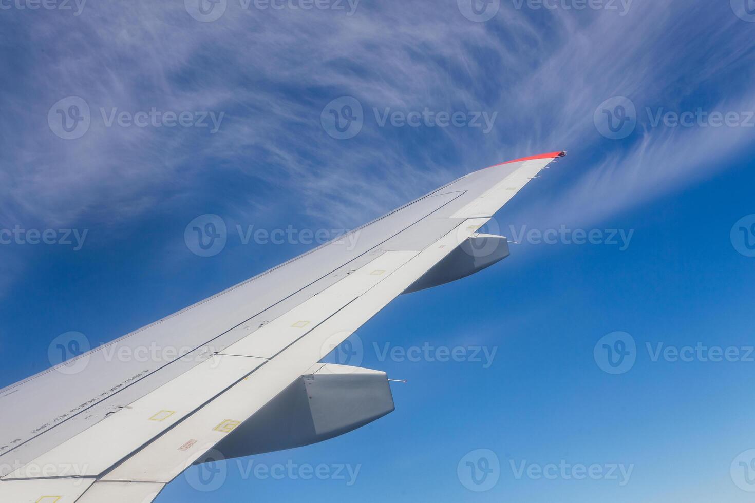 View from airplane window with blue sky and white clouds photo