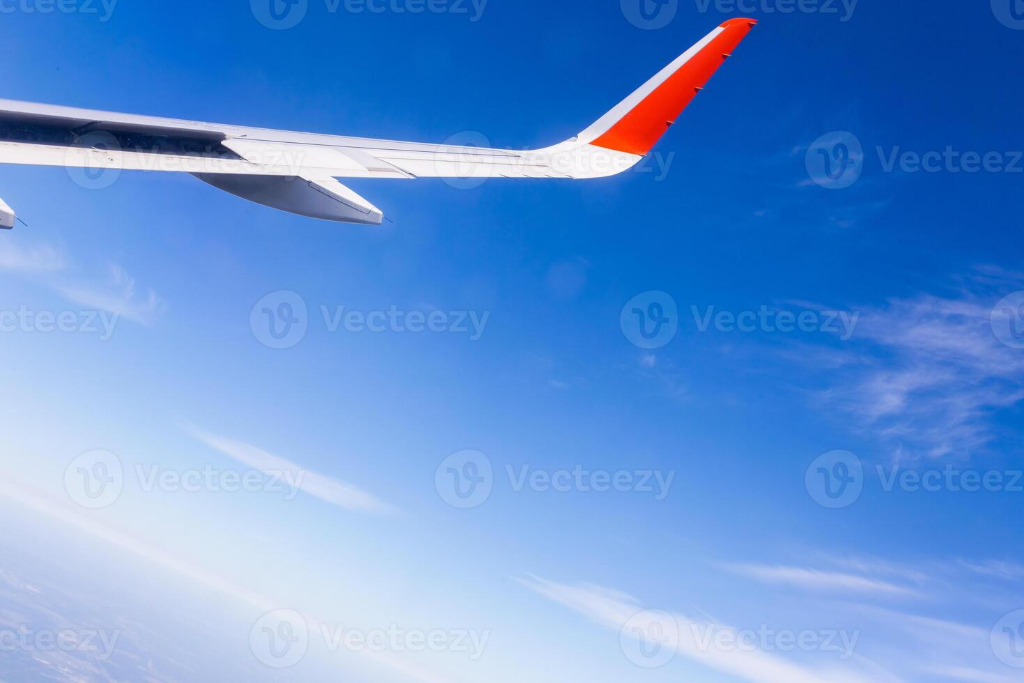 View from airplane window with blue sky and white clouds photo