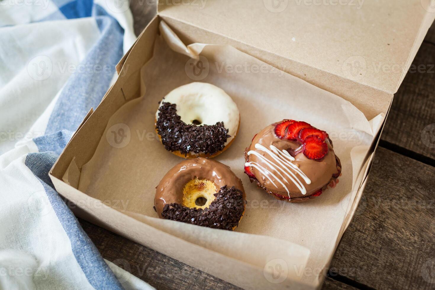 Colorful donuts in box photo